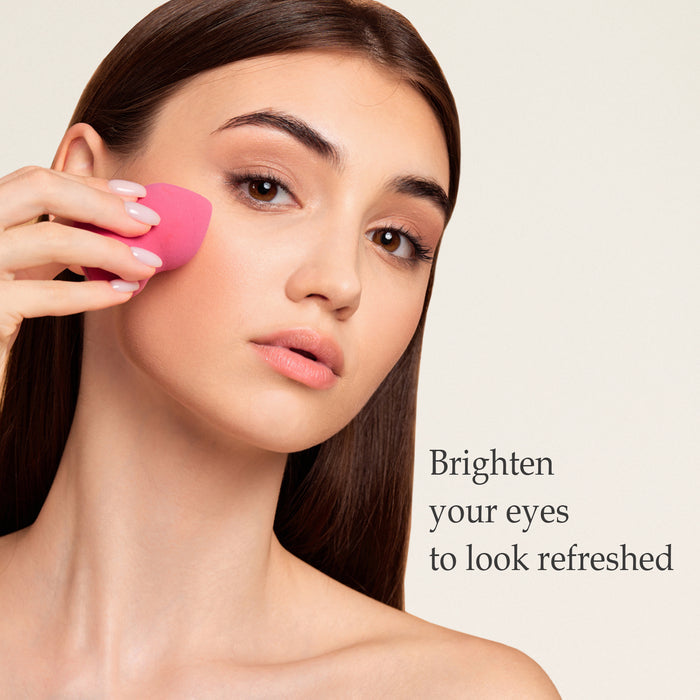 Woman using a sponge applicator to apply Demure Concealer under her eyes.
