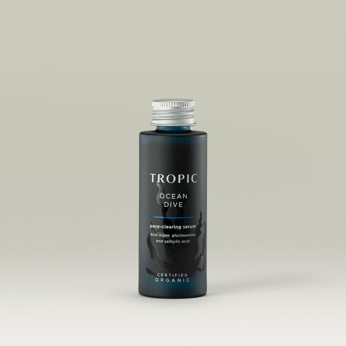 Tropic Ocean Dive Pore-Clearing Serum refill bottle in a deep blue hue with a silver cap, formulated with blue algae, glucosamine, and salicylic acid to purify and refine pores.