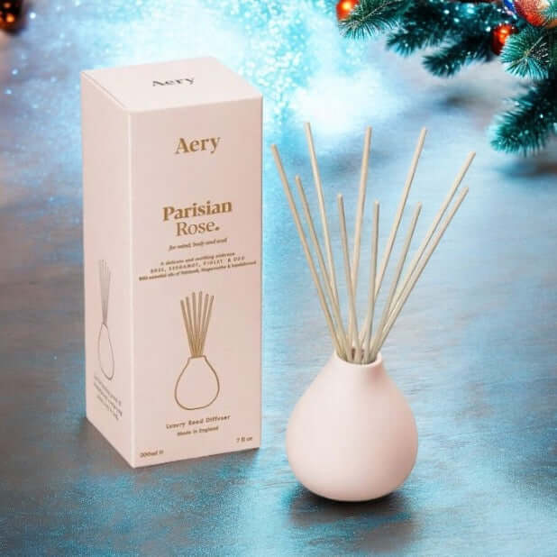 Parisian Rose Reed Diffuser in a stylish white vase with reed sticks, perfect for adding glamour to any space.