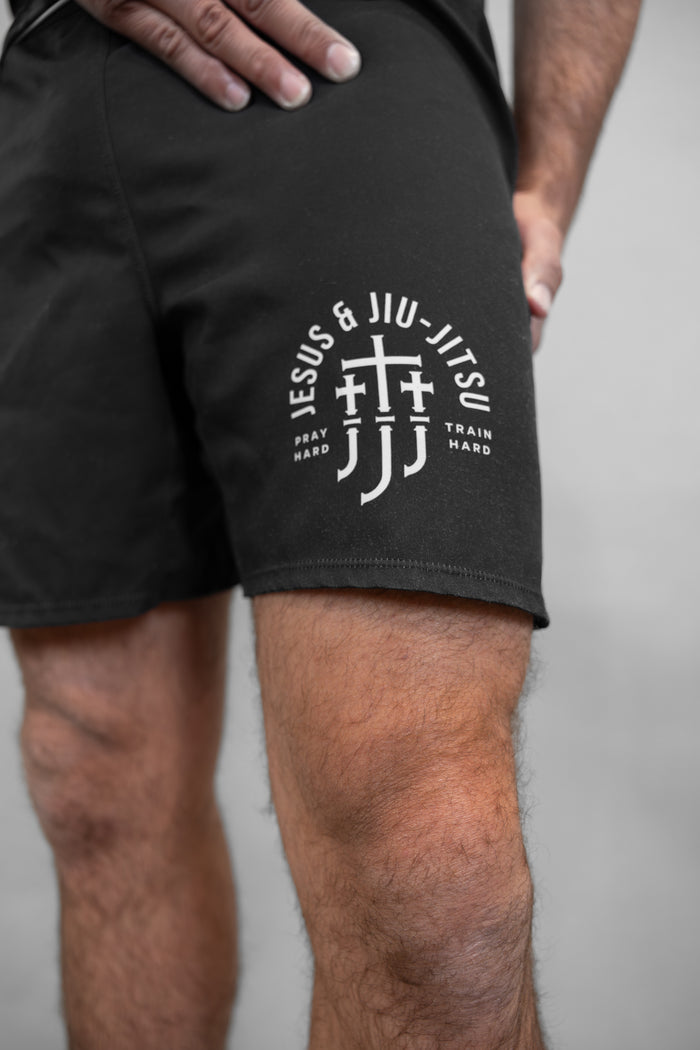 Black shorts with Jesus & Jiu Jitsu logo with "PRAY HARD TRAIN HARD" text