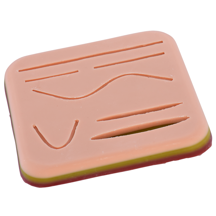 A pink practice skin displays various suture patterns; it is a training aid for medical professionals.