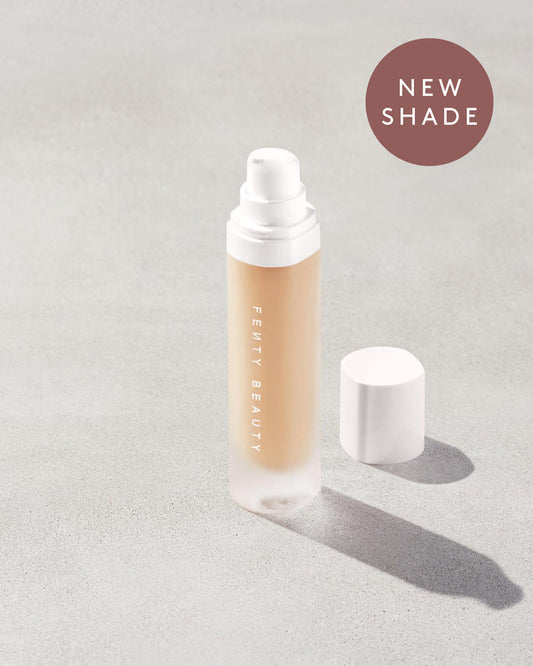 open bottle of Fenty Beauty Pro Filt'r Soft Matte Longwear Foundation with pump dispenser in shade #175 on concrete background