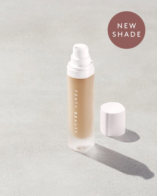 open bottle of Fenty Beauty Pro Filt'r Soft Matte Longwear Foundation with pump dispenser in shade #225 on concrete background