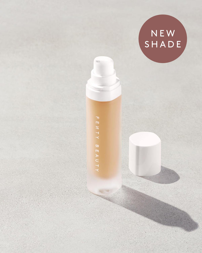 Open bottle of a new shade of Fenty Beauty Pro Filt'r Soft Matte Longwear Foundation with pump dispenser in shade #265 on concrete background