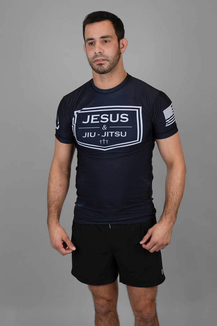 Man wearing rashguard with "JESUS & JIU-JITSU" logo