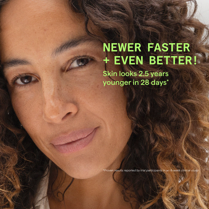Close-up portrait of a woman with curly brown hair and natural skin, with bright green promotional text reading 'NEWER FASTER + EVEN BETTER! Skin looks 2.5 years younger in 28 days' and small disclaimer text at the bottom.
