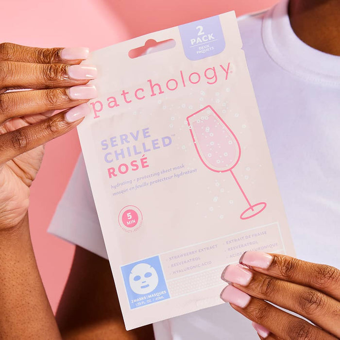 Hands holding Patchology Serve Chilled Rosé sheet mask 2-pack, hydrating and brightening skincare product on pink background