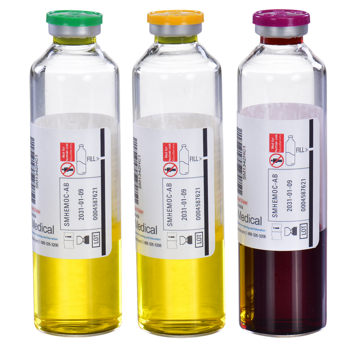 Three glass vials containing different colored liquids sit side-by-side. Each vial is labeled "SMHEMOC-AB," "2031-01-09," and "0004587621." One vial has a yellow liquid, another yellow, and the third a dark red liquid.