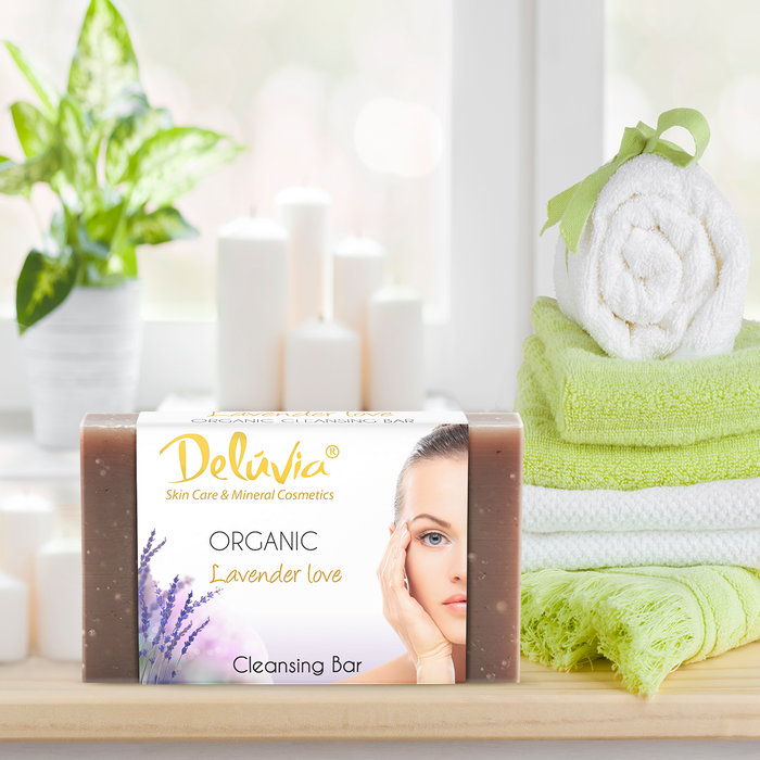 Deluvia Soap bar on a bathroom counter with some towels and a plant