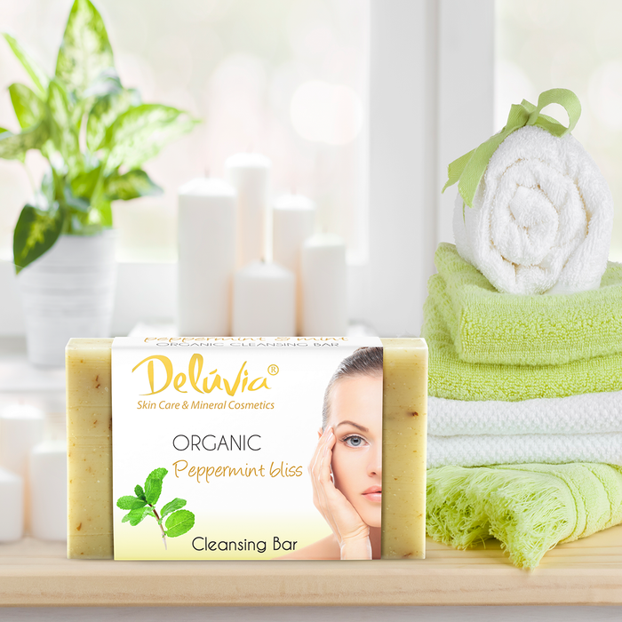 Deluvia Soap bar on a bathroom counter with some towels and a plant