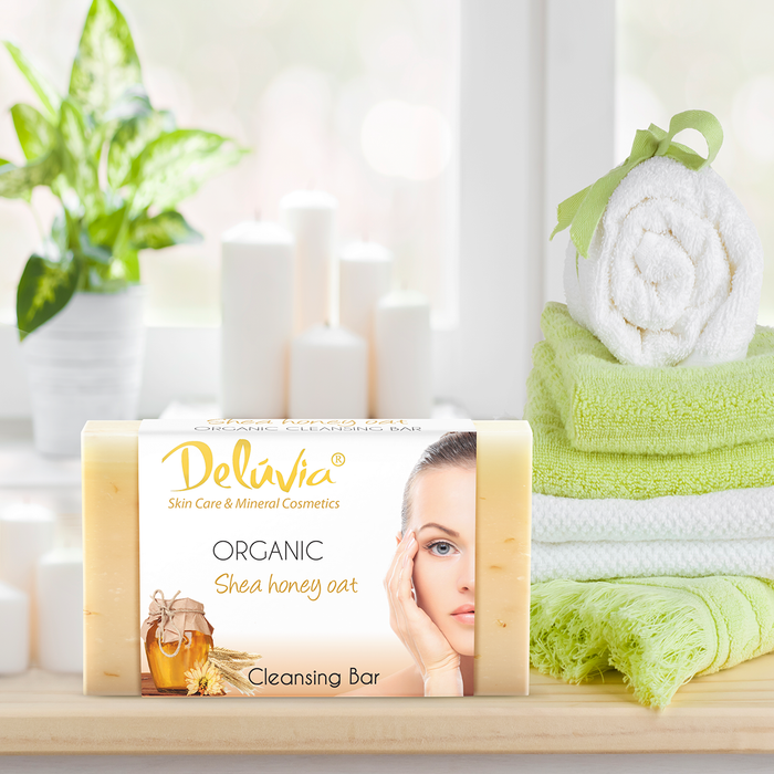 Deluvia Soap bar on a bathroom counter with some towels and a plant