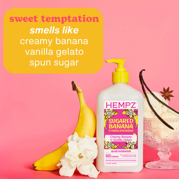 Hempz Sugared Banana and Vanilla Blossom product with banana, flowers, and vanilla bean on a pink background