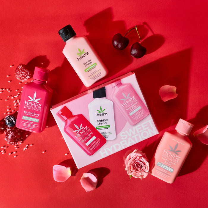 Hempz Sweet Hydration Mini Lotion Trio Set  on a red background with cherries, berries and flowers