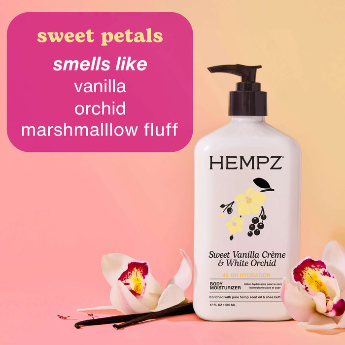 Hempz Sweet Vanilla Creme & White Orchid body moisturizer with flowers and vanilla bean on a pink background