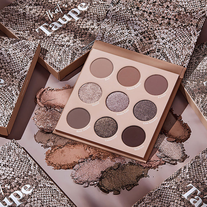 Open That’s Taupe ColourPop Shadow Palette showcasing nine cool taupe neutrals in matte and metallic finishes - pans labeled Slated, Snake Eyes, and Bedrock - surrounded by powder swatches and snake‑print boxes.