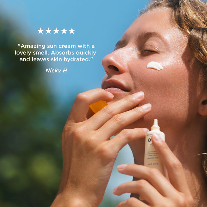 Person applying Tropic Sun Day SPF 50 facial sunscreen with five-star customer review: "Amazing sun cream with a lovely smell. Absorbs quickly and leaves skin hydrated." – Nicky H.