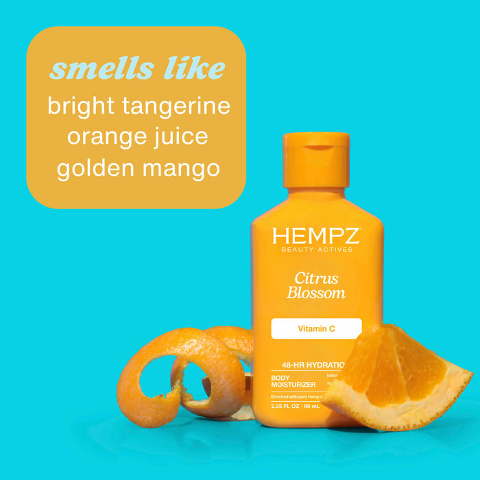 Hempz Citrus Blossom body moisturizer bottle with orange slices on a blue background with scent notes