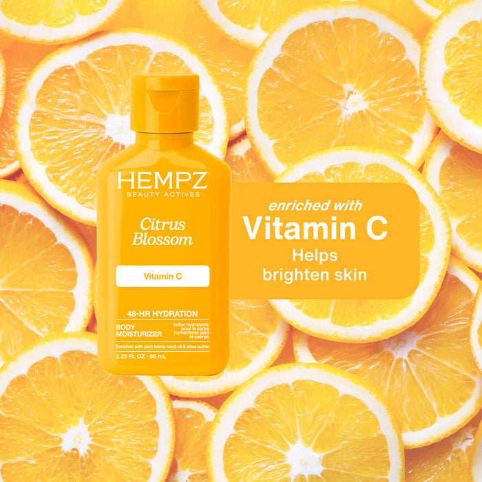 Hempz Citrus Blossom body moisturizer bottle on a background of orange slices, highlighting vitamin C benefits