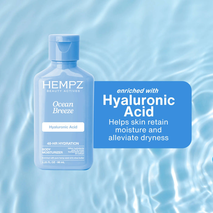 Hempz Ocean Breeze body moisturizer bottle with hyaluronic acid on a blue water background