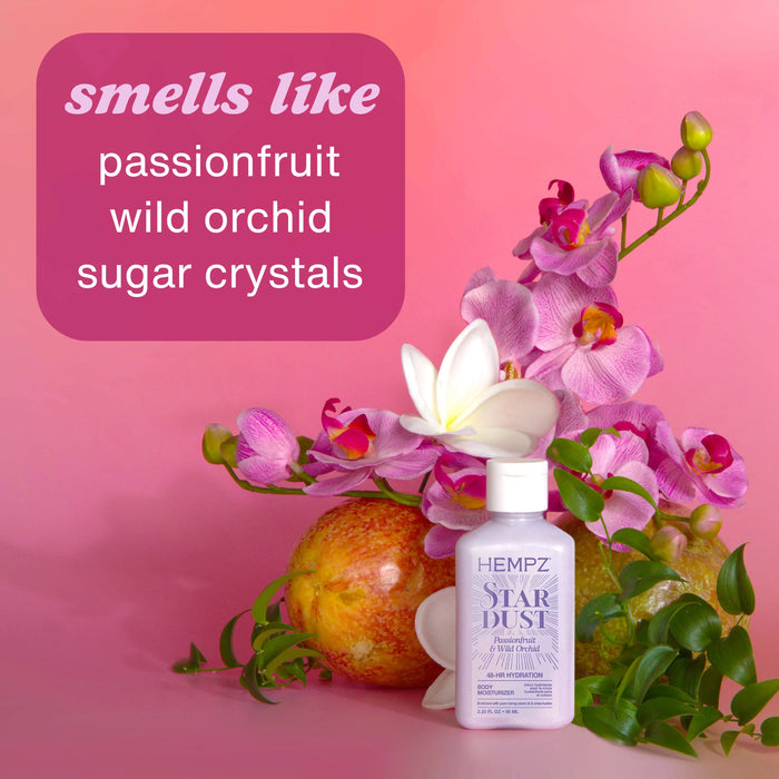 Hempz Star Dust perfume bottle with flowers and text on a pink background