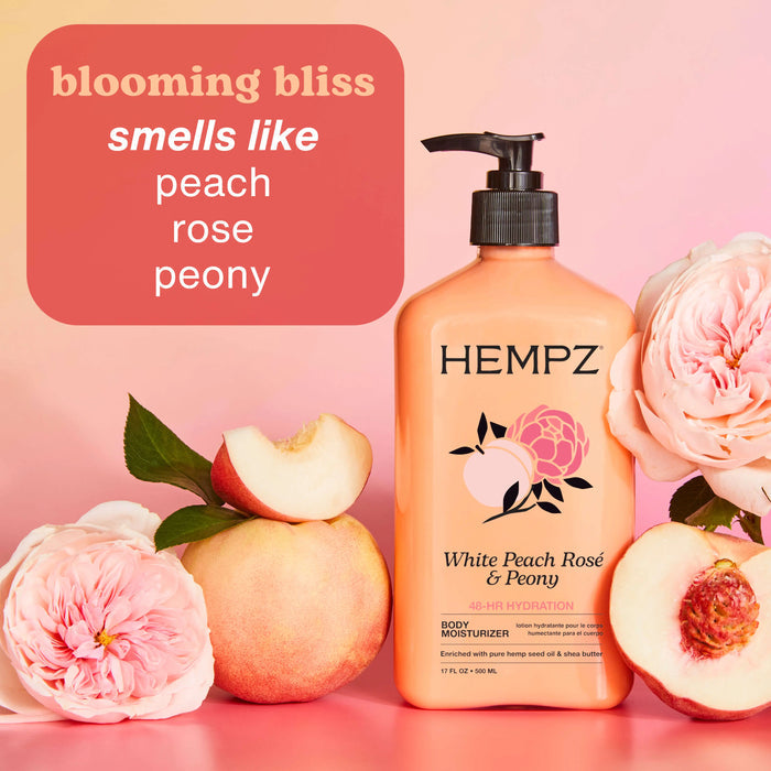 Hempz White Peach Rosé & Peony body moisturizer with peaches and flowers on a pink background