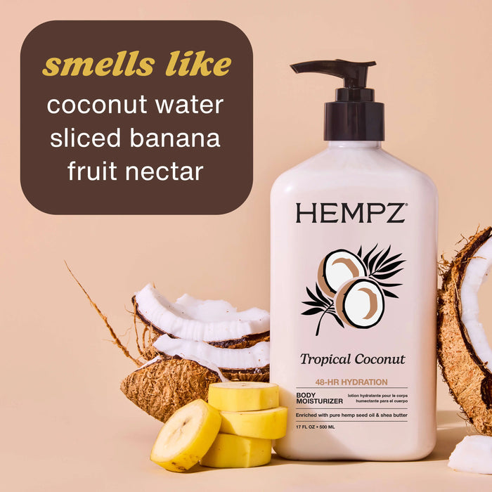 Hempz Tropical Coconut body moisturizer with coconuts and banana slices on a beige background