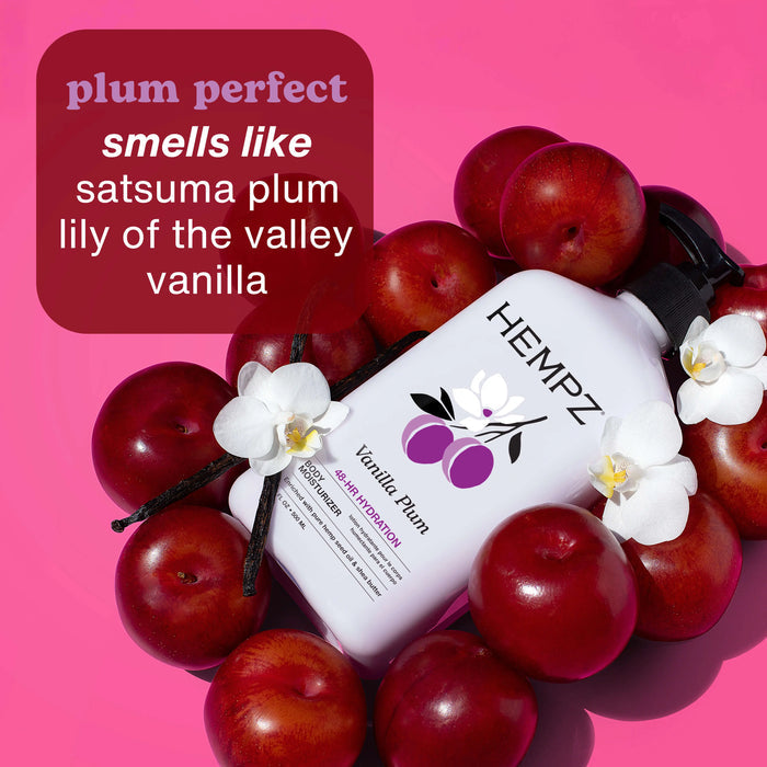 Hempz Vanilla Plum moisturizer bottle surrounded by plums and vanilla beans on a pink background describing scent notes