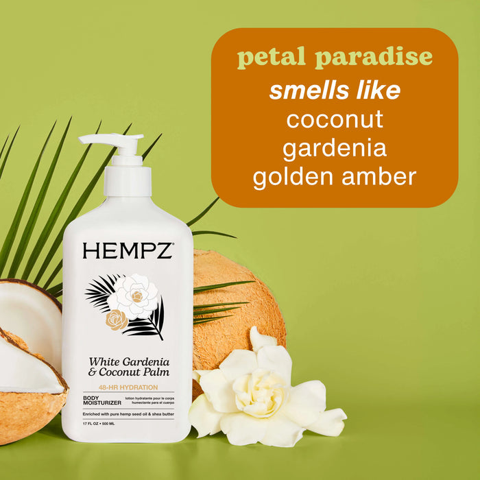 Hempz White Gardenia & Coconut Palm body moisturizer with coconut and gardenia on a green background
