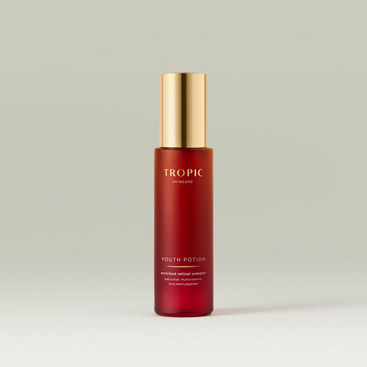 Tropic Youth Potion serum bottle with a gold pump on a neutral background.