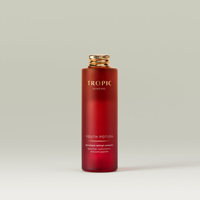 Tropic Youth Potion refill bottle with a gold cap on a neutral background.