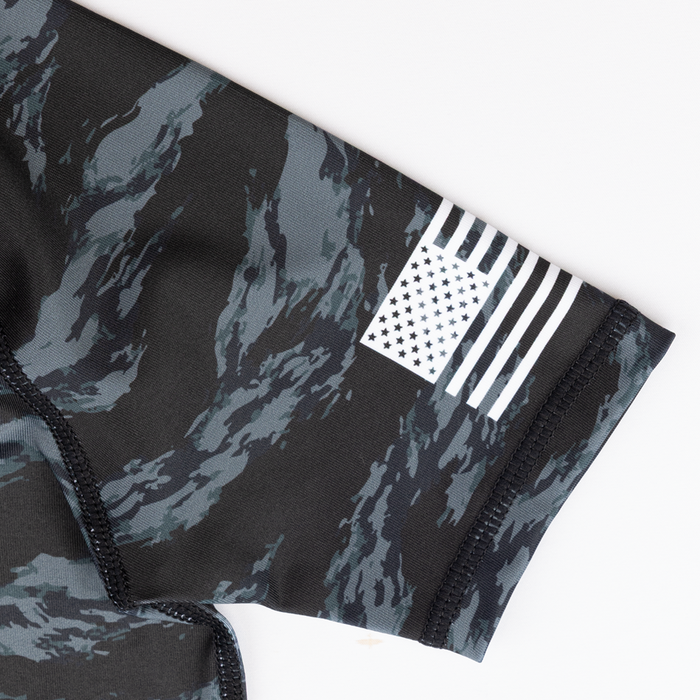 Black camouflage-patterned Youth rashguard white flag design on sleeve